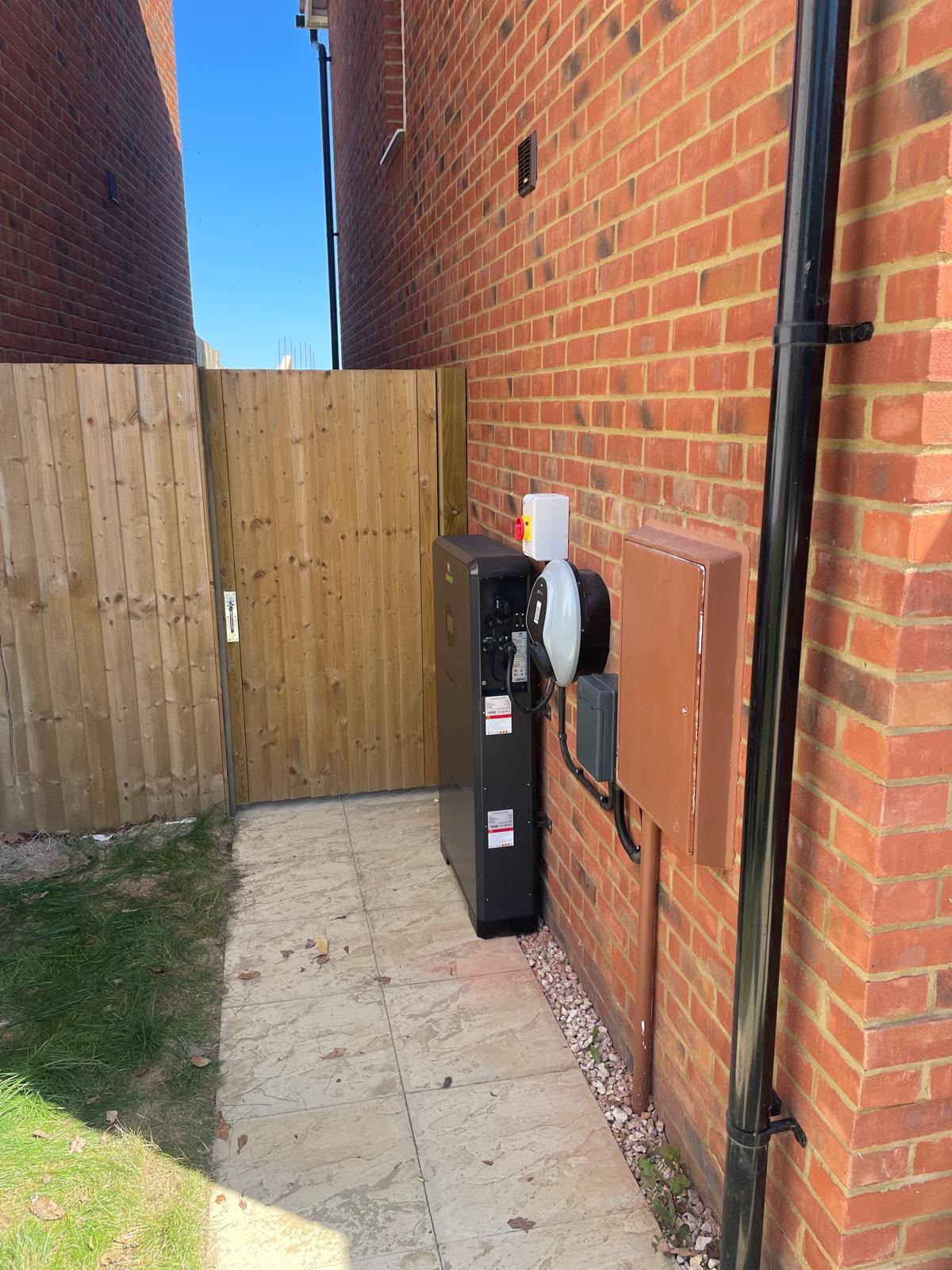 Side view showing how little the battery projects from the wall beside a paved side passage